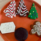 Top row, left: Christmas Tree Cake, Chocolate Christmas Tree Cake, Christmas Tree Brownie. Bottom row, left: Snowflake Brownie, Cherry Cordial, Gingerbread Cookie.